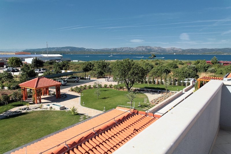 The view of the garden, surroundings and sea from the luxury villa for sale on Murter is at its finest