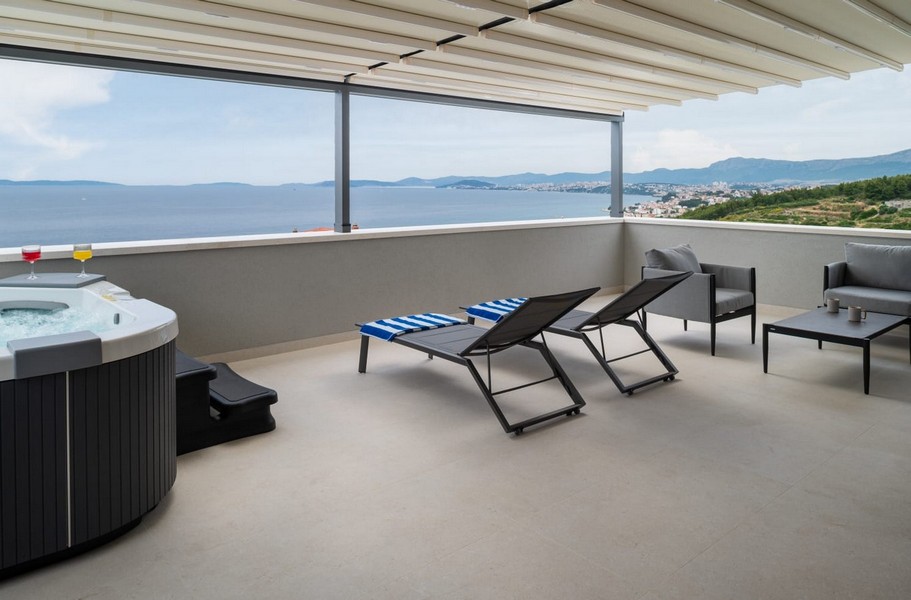 Covered terrace with hot tub and sea views