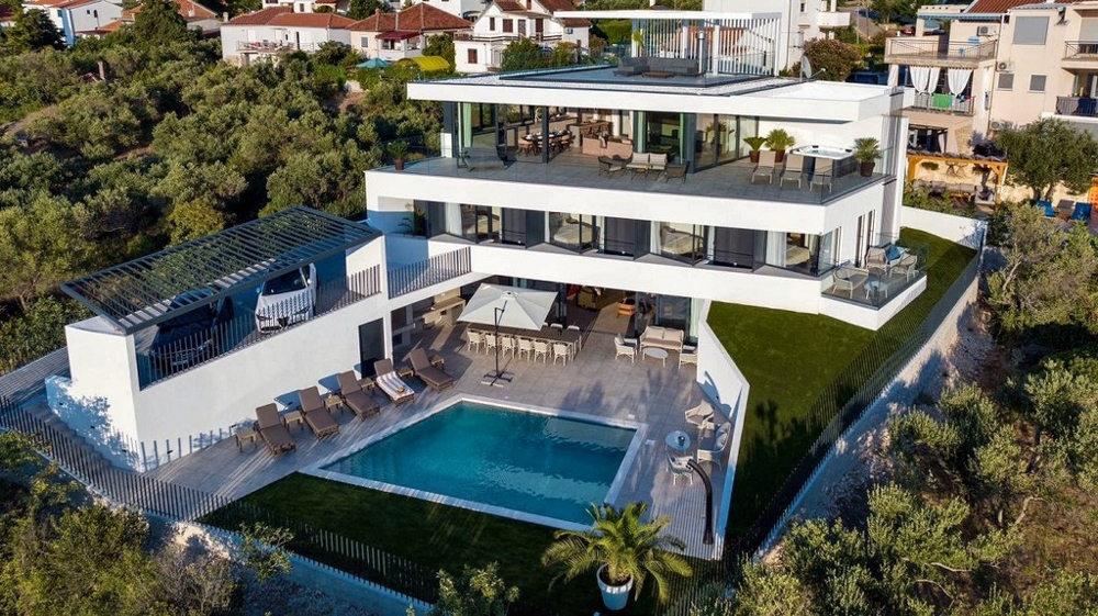 Aerial view of a villa for sale in Croatia with a roof terrace and pool.