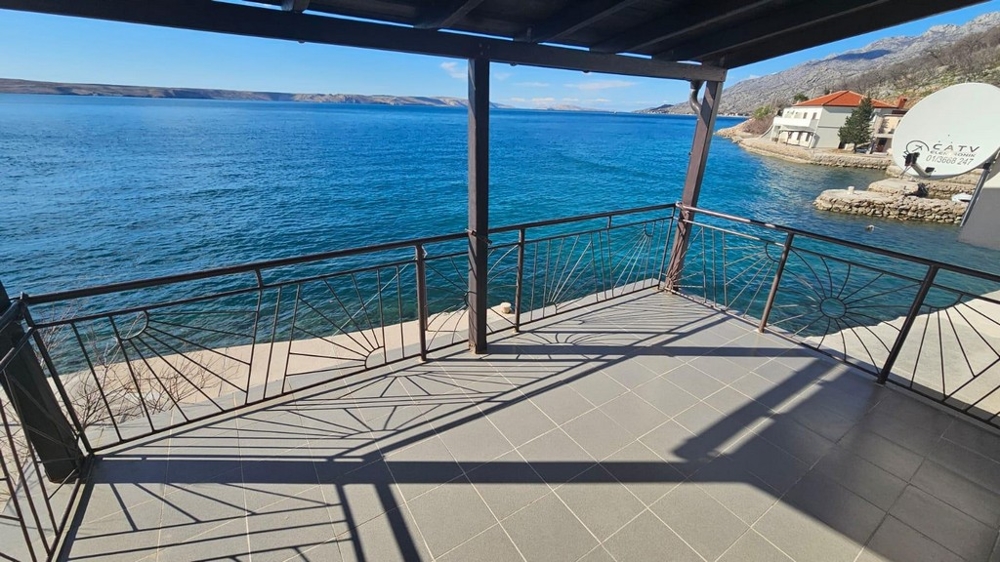 Real estate Croatia, house right by the sea, veranda with sea view in Karlobag