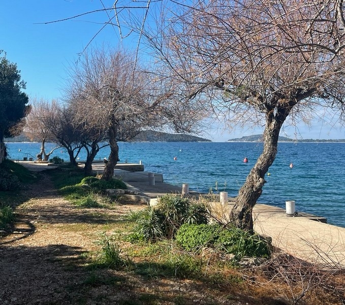 Coastal promenade near the semi-detached house for sale overlooking the sea in Zaboric, Croatia