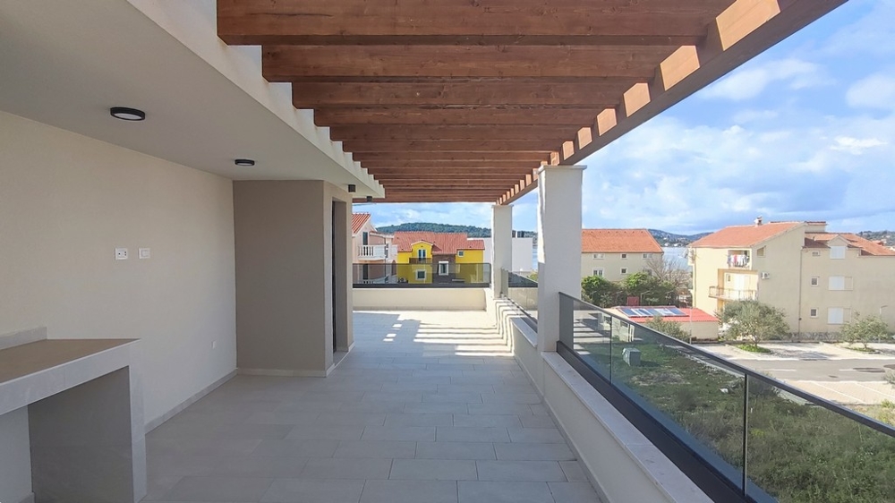 Spacious covered terrace with wooden ceiling on a modern semi-detached house for sale in Croatia