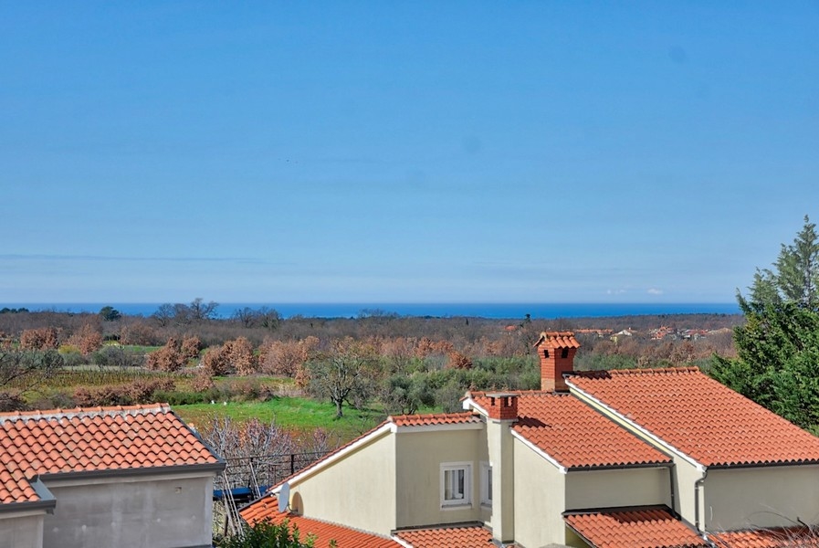 View of the sea and surrounding roofs from the upper terrace of the new semi-detached house in Istria