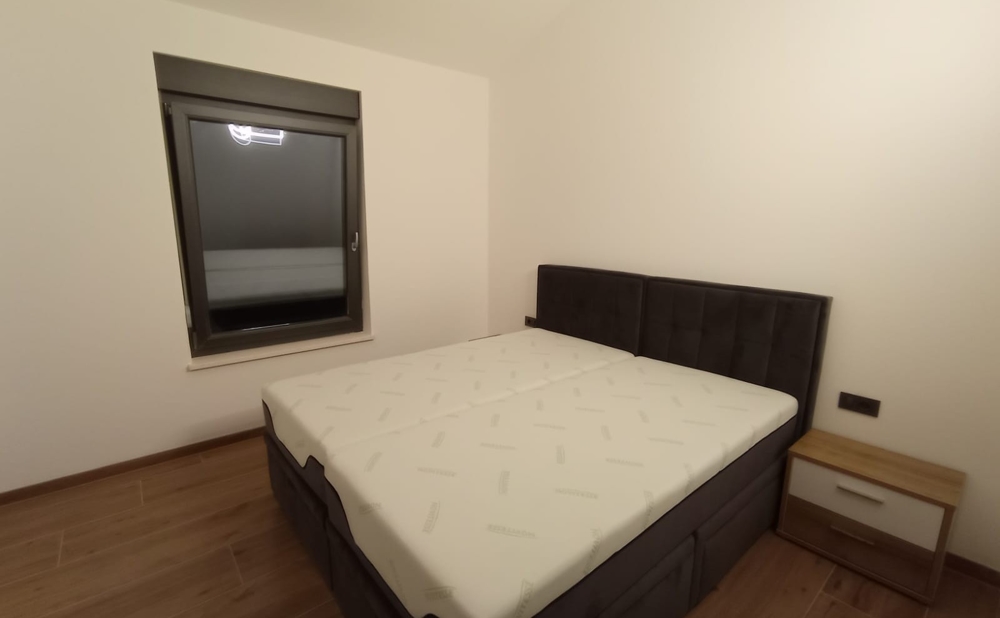 Simple bedroom with double bed in a property in Croatia, night window closed.