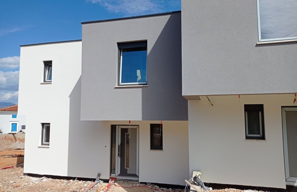 The exterior view in daylight of a newly completed property for sale in Croatia.