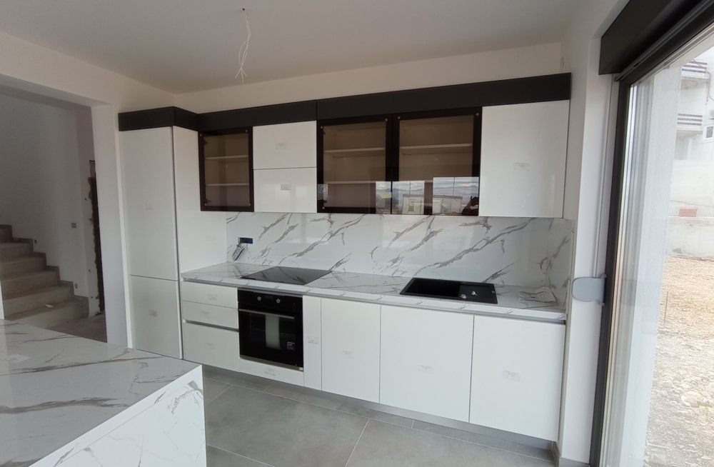 Interior view of a modern kitchen with white furniture in a property in Croatia.