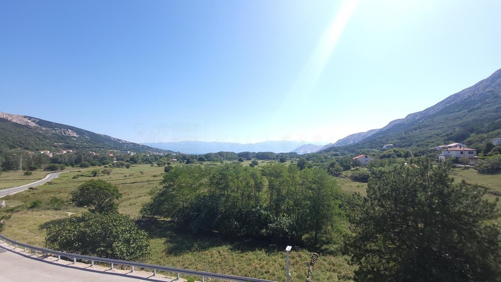 Apartment house with pool in Baska, Krk Island, view across the valley to the sea
