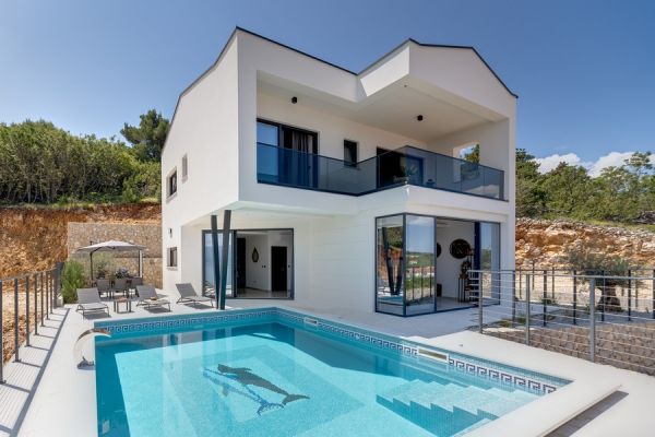 Modern white villa with pool on the island of Krk, surrounded by Mediterranean vegetation.