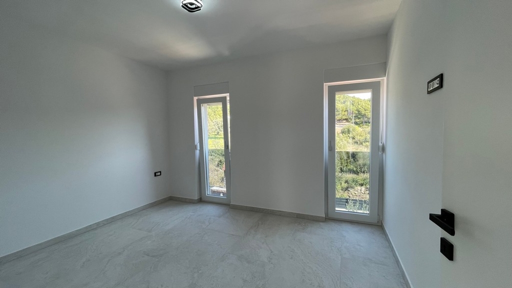 Room with two floor-to-ceiling windows