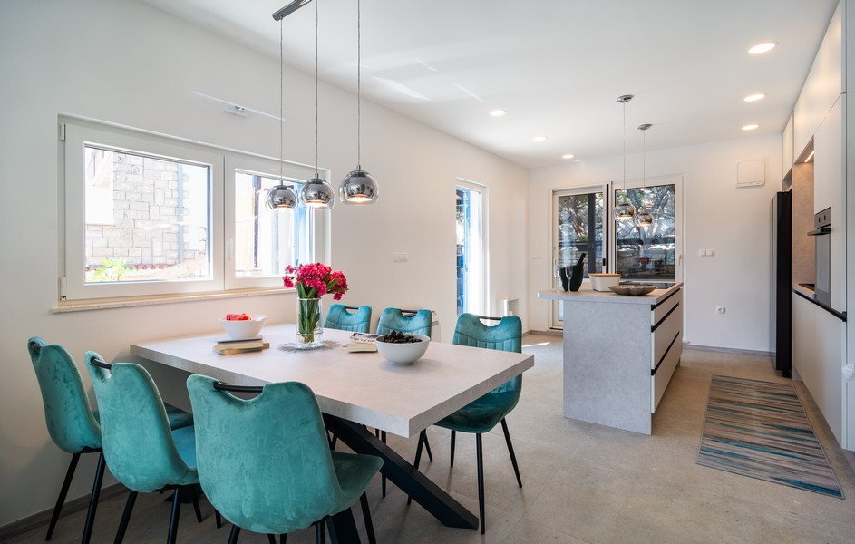 Dining area with a large table and modern kitchen