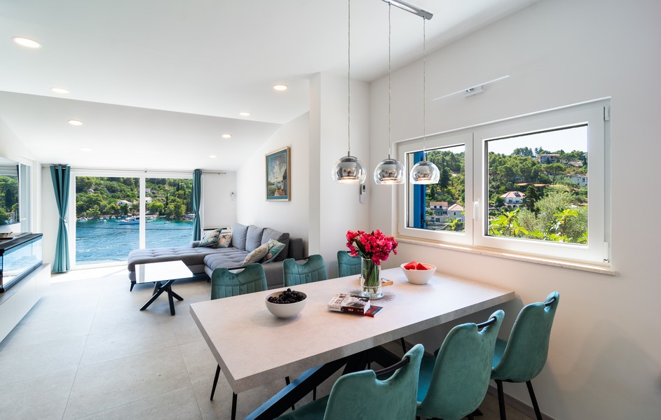 Bright living room with dining table and view of the bay