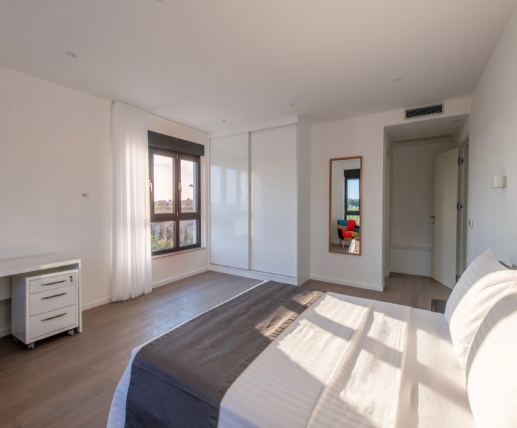 Bright bedroom with double bed and built-in wardrobe