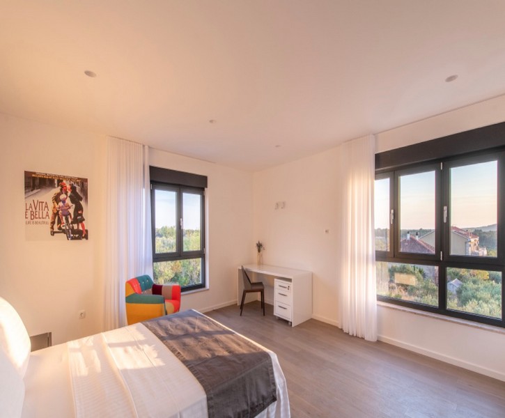 Bedroom with desk and panoramic windows