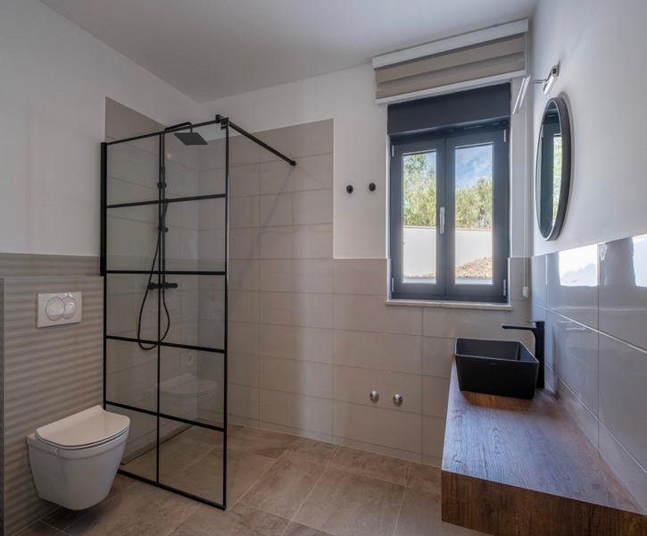 Modern bathroom with large shower and wooden vanity