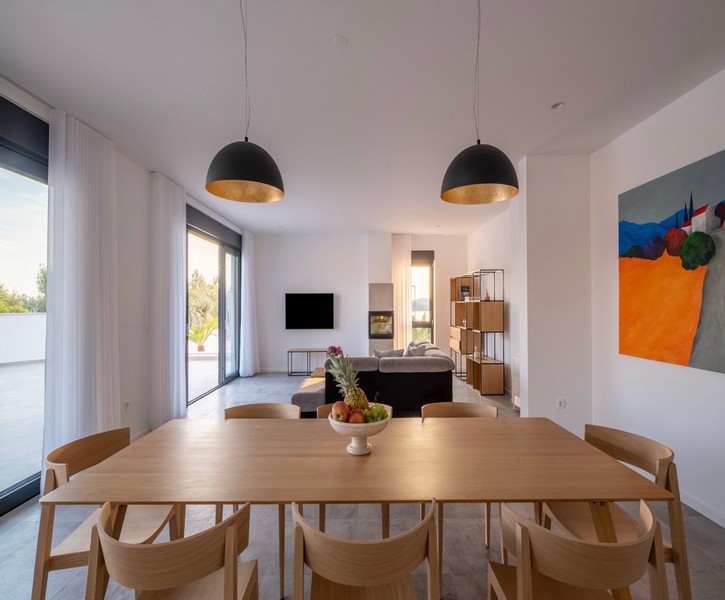 Dining area with large wooden table and view into the living room