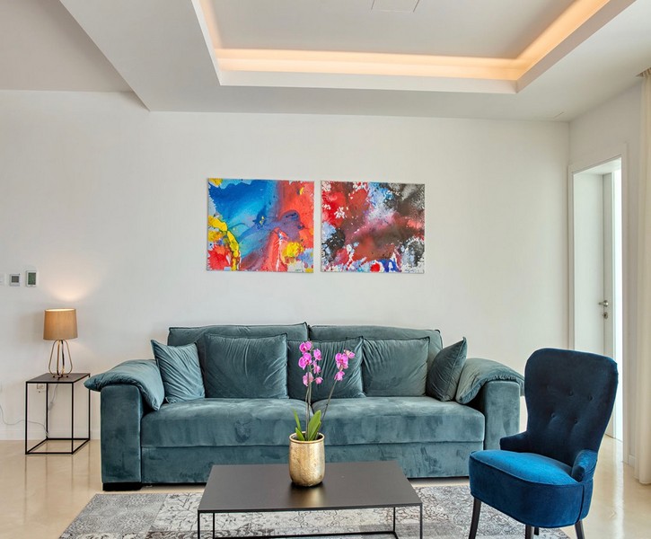 Living area with sofa and colorful wall art