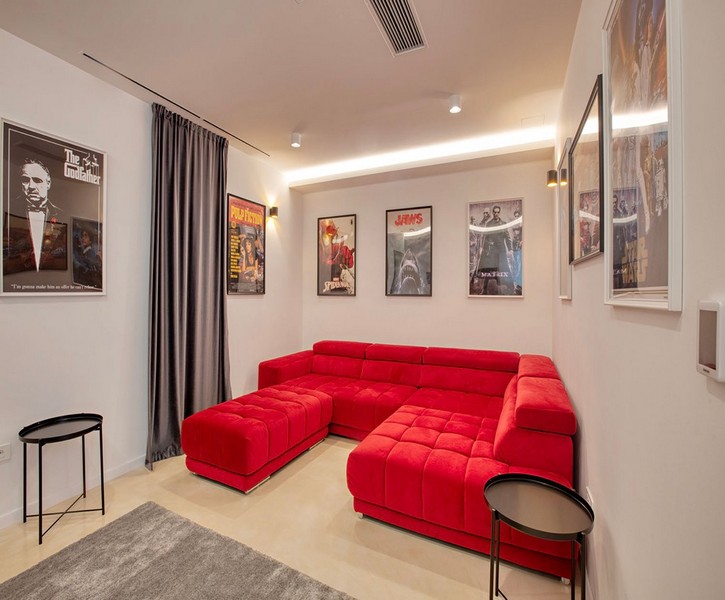 Home theater with red sofa and movie posters