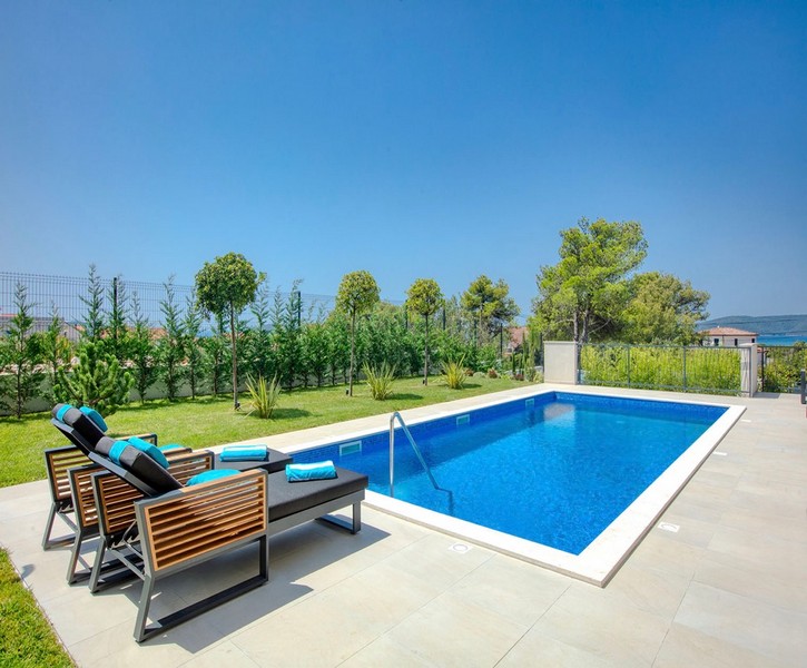 Swimming pool with garden and sea views