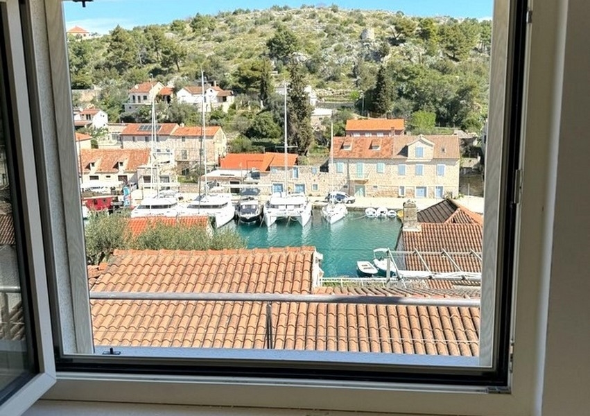View from window overlooking harbor and boats