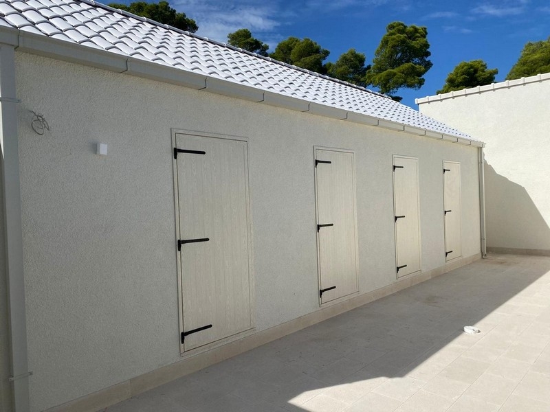 Building with several doors and light facade