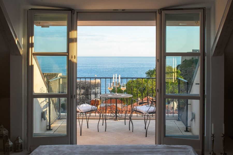 Terrace with sea views through opened doors