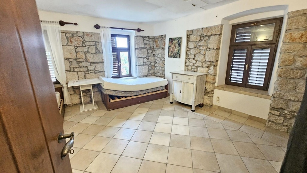 Bedroom with stone wall accents