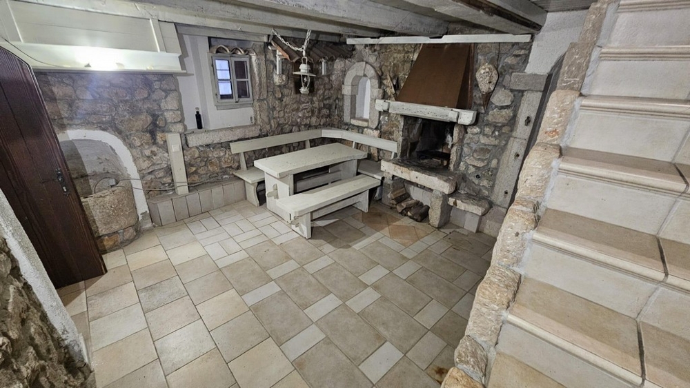 Rustic room with stone walls and fireplace