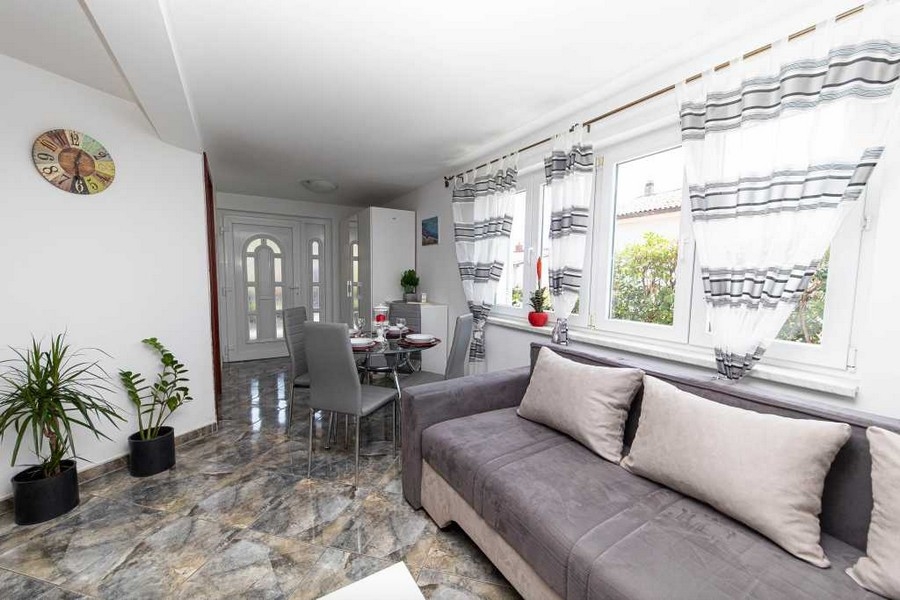 Living room with large window front and dining area