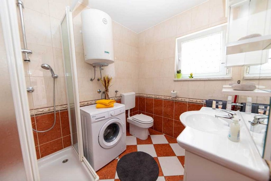 Bathroom with shower and washing machine