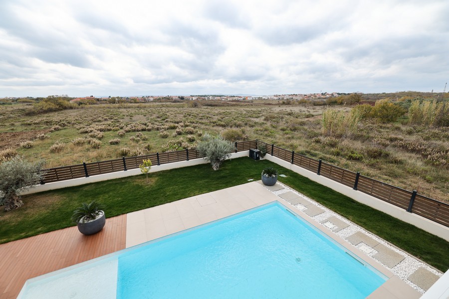 Swimming pool and view of the surroundings of Privlaka, Croatia.