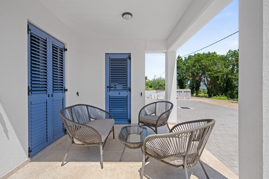 Terrace with seating area and house entrance