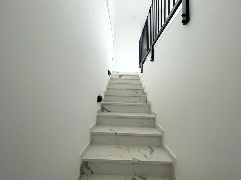 Stairs to the upper floor with stone paving