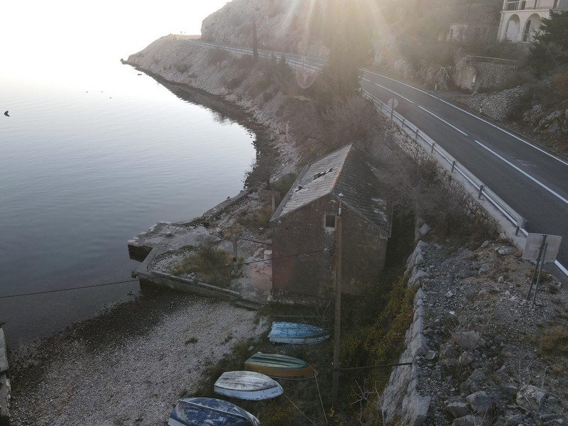 Stone house right by the sea below the coastal road in Croatia