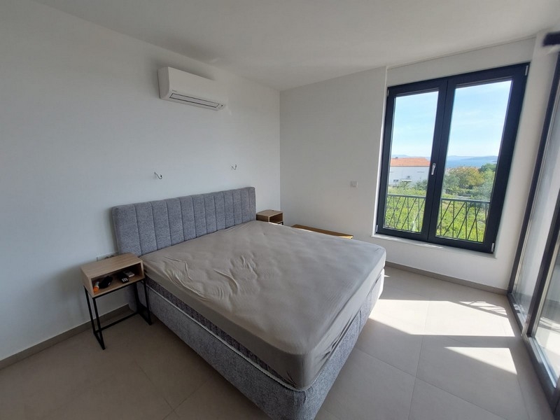 Bedroom with large windows and air conditioning