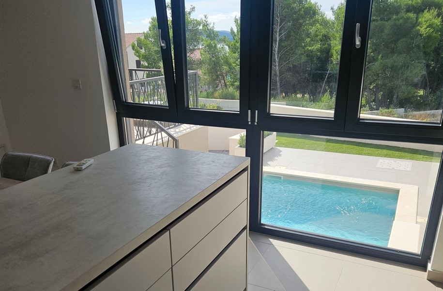 Kitchen area overlooking pool and garden