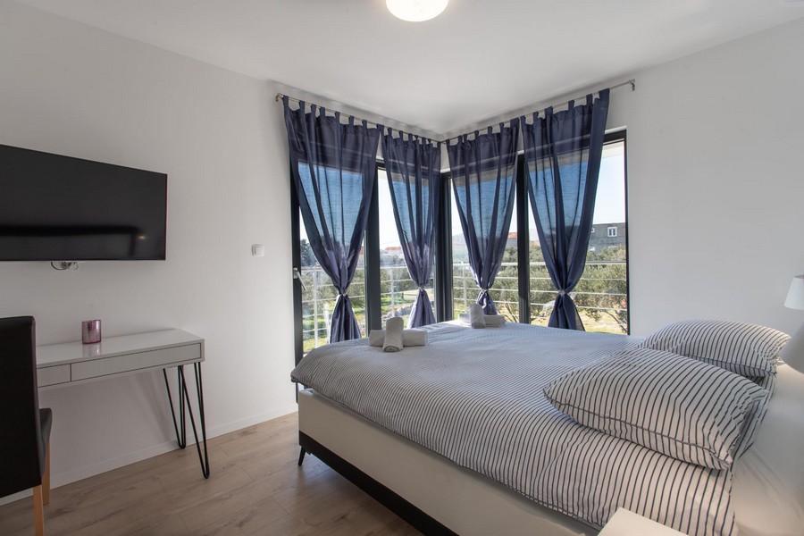 Living area with large glass front of property H1720, Kastela, Croatia.