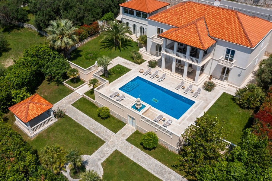 Aerial view of the villa with pool area and garden
