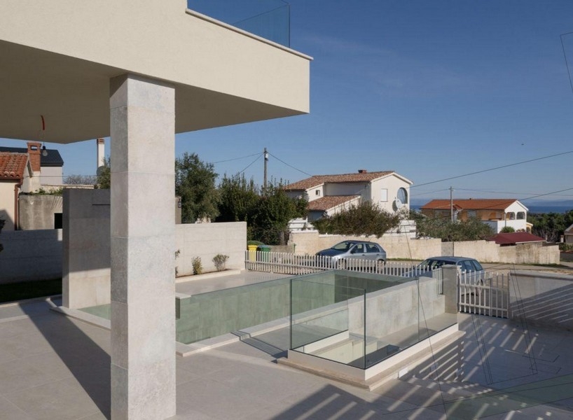 Covered terrace with pool and glass railings