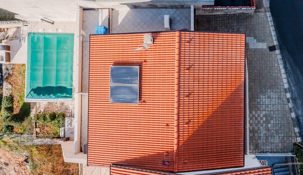 Aerial view with pool and red tiled roof in Crikvenica