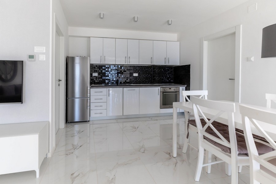 Modern kitchen with white fitted kitchen and dining area