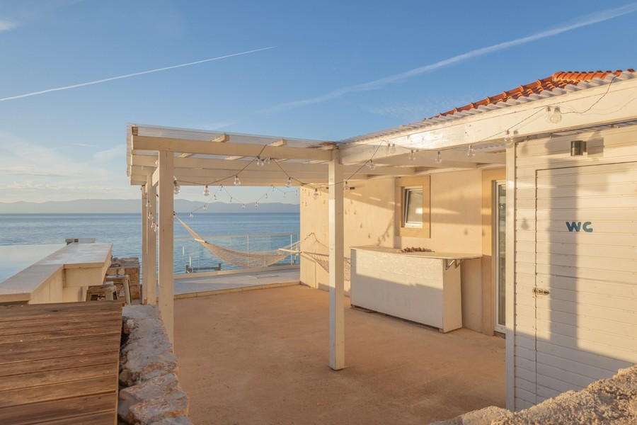 Covered terrace with outdoor bar and sea views