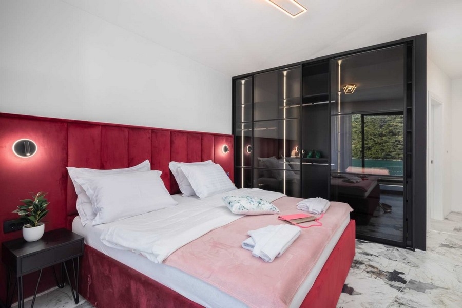 Bedroom with built-in wardrobe and water views