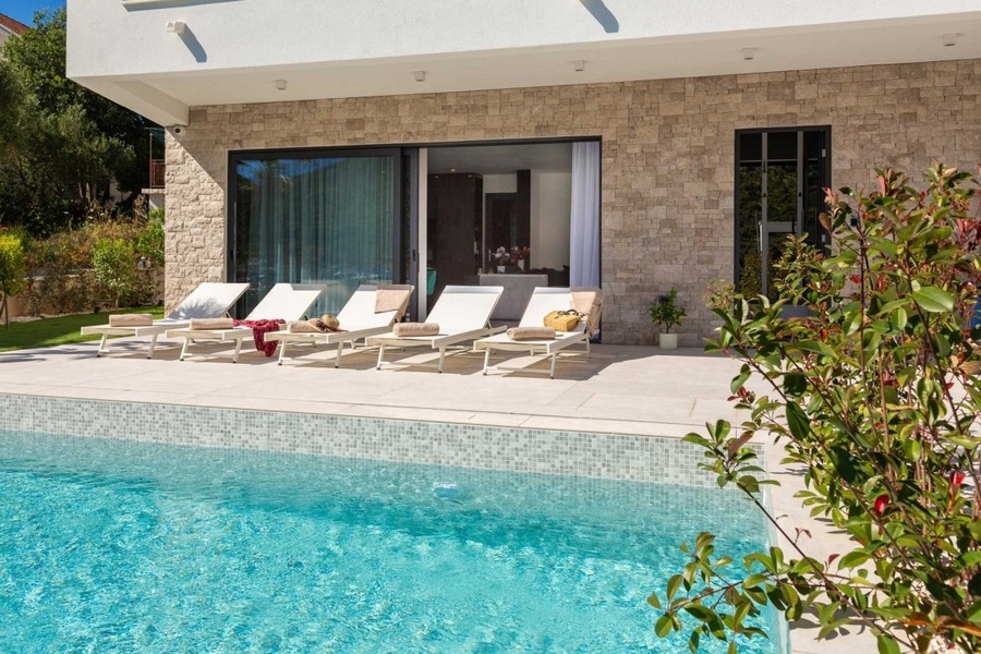 Sun terrace with loungers by the swimming pool