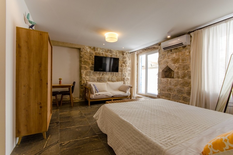 Bedroom with natural stone wall and air conditioning