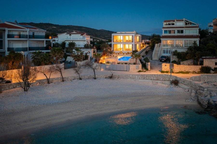 Property near the beach with illuminated outdoor area in the evening