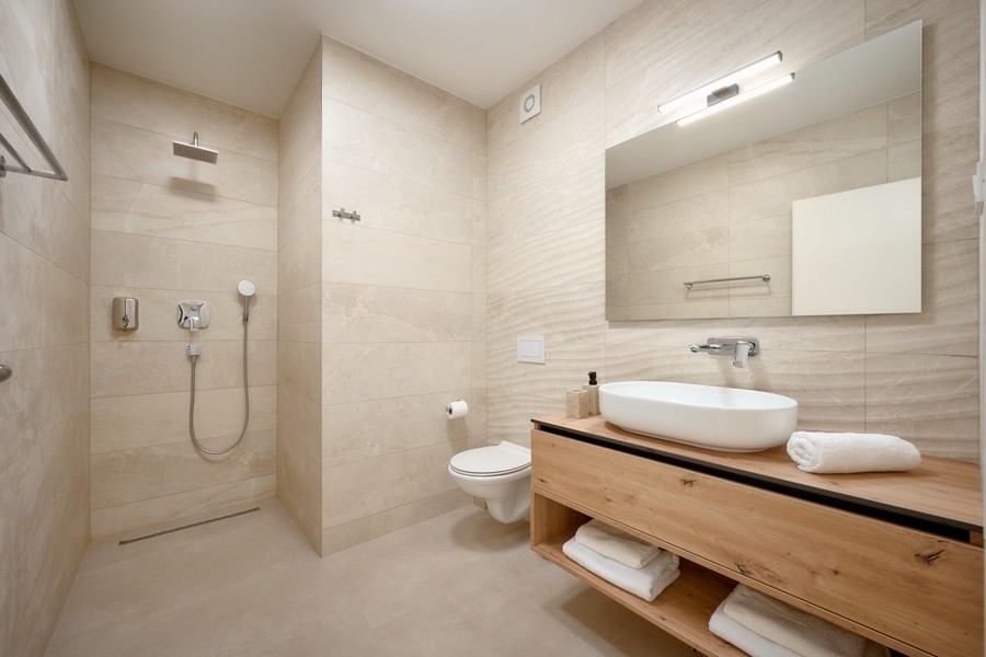 Modern bathroom with floor-level shower and vanity
