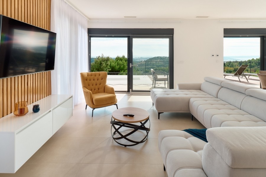 Open living area with floor-to-ceiling windows and access to the terrace