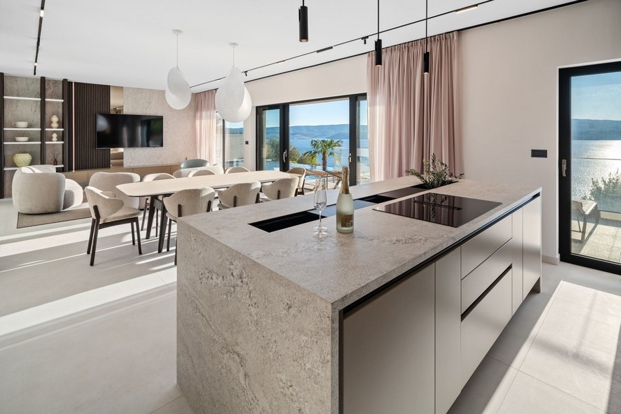 Modern kitchen with island and dining area with sea views