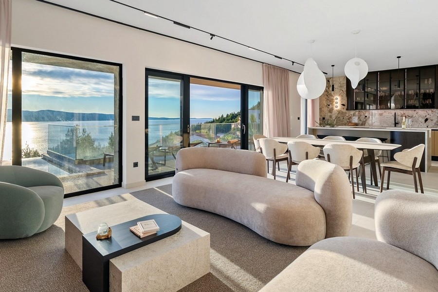 Living area with floor-to-ceiling windows and sea views