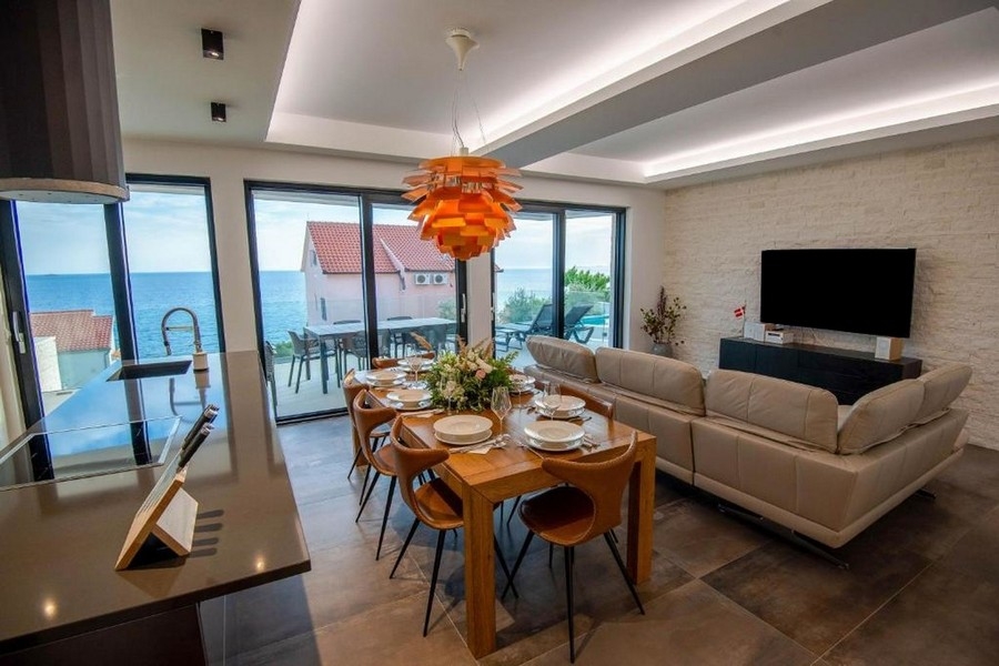 Open living and dining area with sea views and access to the terrace